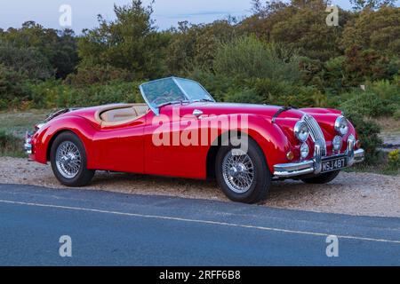 Roter Jaguar XK 140 XK140, Modelljahr 1955, im Juli in Studland, Dorset, Großbritannien geparkt Stockfoto