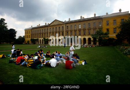 Studenten des Oxford England Magdalen College der Oxford University sitzen auf dem Croquet Lawn vor dem New Building, das im 18. Cent errichtet wurde Stockfoto