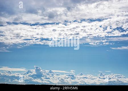 Blauer Himmel mit stürmischen und welligen weißen Wolken vor Regen. Wetterwechsel Stockfoto
