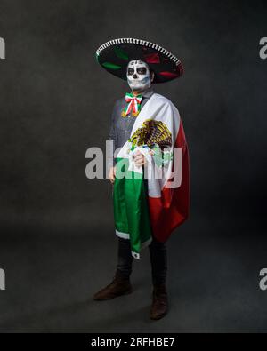 Porträt von catrin mit Charro-Hut und mexikanischer Flagge. Der Tag der Toten. Stockfoto
