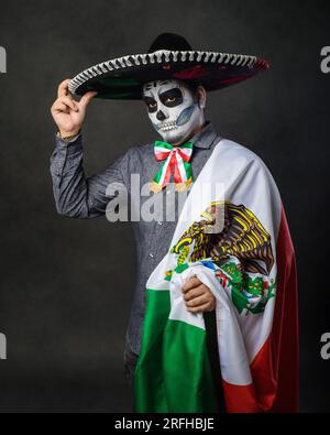Porträt von catrin mit Charro-Hut und mexikanischer Flagge. Der Tag der Toten. Stockfoto