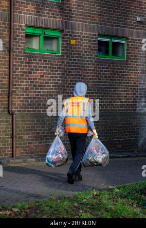 Plastiktüten voller Müll werden vom Community Payback Team vom Gelände eines Sportzentrums entfernt. Stockfoto