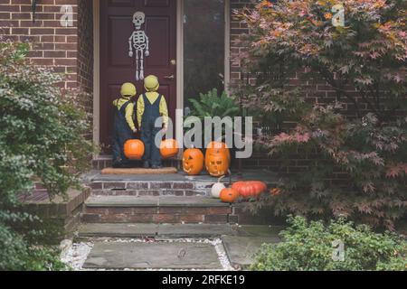 Junge Jungs nähern sich der Haustür, um an Halloween Süßes oder Saures zu spielen. Stockfoto