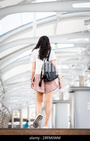 Ein junges thailändisches Mädchen geht durch den Chong Nonsi BTS Sky Train Bahnhof in Bangkok Thailand. Stockfoto