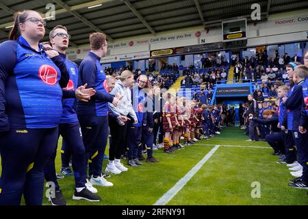 Mitglieder der Warrington Wolves Academy, Women's, Rollstuhl und PDRL begrüßen die Spieler auf dem Spielfeld vor dem Spiel der Betfred Super League Runde 21 Warrington Wolves vs Catalans Dragons im Halliwell Jones Stadium, Warrington, Großbritannien, 4. August 2023 (Foto: Steve Flynn/News Images) Stockfoto