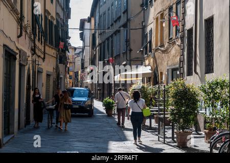 Eine der vielen engen mittelalterlichen Hauptstraßen, die bei Touristen beliebt ist, ist die Via S. Padino in der Stadt Lucca in der Toskana in Italien. Stockfoto