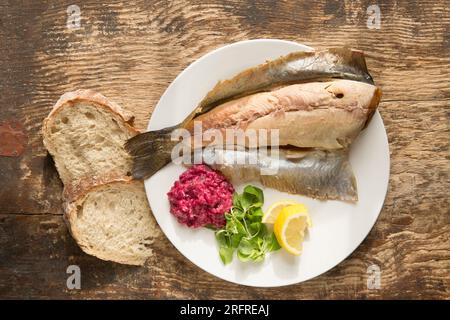 Heiße geräucherte Regenbogenforelle, Oncoryhnchus mykiss, serviert mit Meerrettich- und Rote-Bete-Sauce, Lammsalat und Zitronenscheiben. England GB Stockfoto