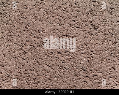 Ungleichmäßige Körnung von trockener verdichteter Erde oder Sand von hellgrau-brauner Beige-Farbe Stockfoto