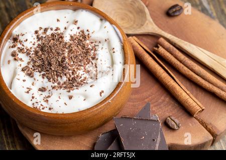 Joghurt aus Sahne mit Schokoladenstücken und Krümeln, hausgemachter Joghurt aus Milchprodukten mit Milchschokolade Stockfoto
