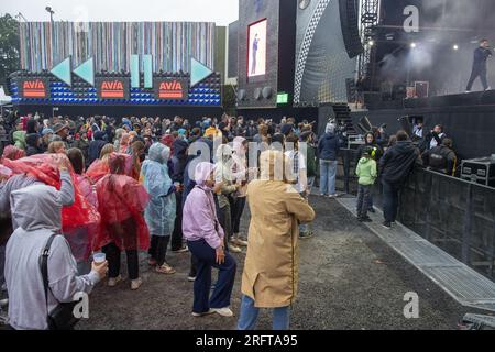 Lokeren, Belgien. 05. Aug. 2023. Das Abbildungsbild zeigt Zuschauer, die eine Show im Regen mit Poncho und Regenschirm und während der Lokerse Feesten, Samstag, den 05. August 2023 in Lokeren, sehen. Das Festival findet vom 4. August bis 13. August statt. BELGA FOTO NICOLAS MAETERLINCK Kredit: Belga News Agency/Alamy Live News Stockfoto