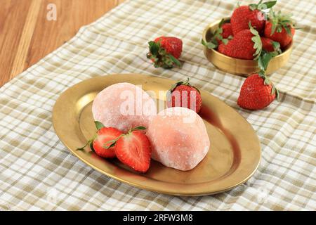 Japanische Süßwaren Ichigo Daifuku, rundes Glutinous Rice Dessert mit frischer Erdbeere. Auf Goldfarbener Ovaler Platte Stockfoto