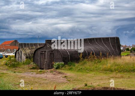 Boote, die als Schuppen auf Lindisfarne benutzt wurden Stockfoto