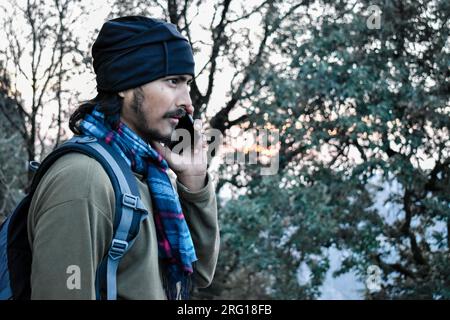 Oktober 14. 2022 Uttarakhand, Indien. Junger Reisender am Telefon während des Winterurlaubs in Mussoorie Hillstation, Uttarakhand, Indien Stockfoto