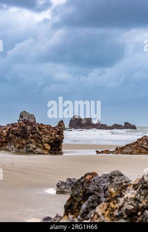 Felsen am Strand von Cape Hillsborough bei stürmischem Wetter, Queensland, Australien. Stockfoto