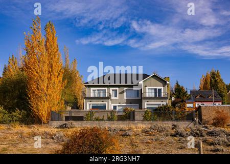 Ein typisches gewelltes Eisenhaus mit herbstlichen Bäumen in Südargentinien, Patagonien, Südamerika Stockfoto