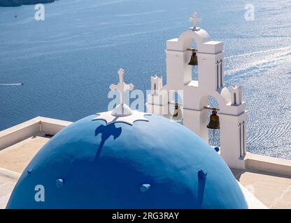 Three Bells of Fira - berühmte Kirche mit blauer Kuppel und Glockenturm mit Meerblick, katholische Dormitionskirche, Firostefani, Santorin, Griechenland Stockfoto