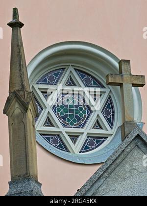 Religiöse Symbole auf einer Kirche im Dorf Vidče in der Nähe der Rožnov pod Radhoštěm in der Tschechischen republik. Betonkreuz und Sechssternchen, auch Hexagramm genannt. Stockfoto