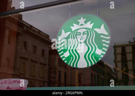 04.08.2023. Barcelona, ​​Spain, starbucks Logo befindet sich auf der rechten Seite direkt am Außenglas des Hotels Stockfoto