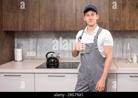 Positiver Klempner zeigt Daumen nach oben Stockfoto