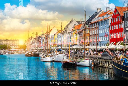 Boote und farbenfrohe Gebäude in Nyhavn Kopenhagen Dänemark bei Sonnenuntergang. Stockfoto