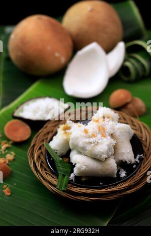 Kue Putu Bambu oder Putu Cake Medan, traditioneller Street Food-Kuchen gefüllt mit Palmenzucker, bedeckt mit geriebener Kokosnuss und grobem Reismehl Stockfoto