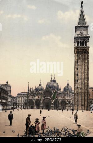 Tauben füttern auf dem Markusplatz in Venedig, Italien, mit der Kathedrale und dem campanile. Vintage 19. Jahrhundert Foto. Stockfoto