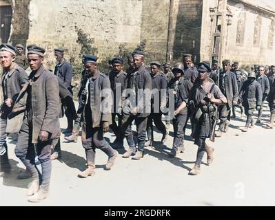 Eine Eskorte des Süd-Staffordshire-Regiments, die während der Schlacht von Albert, während der zweiten Schlacht an der Somme an der Westfront in Frankreich während des Ersten Weltkriegs im August 1918 deutsche Gefangene durch Bucqnoy brachte Stockfoto