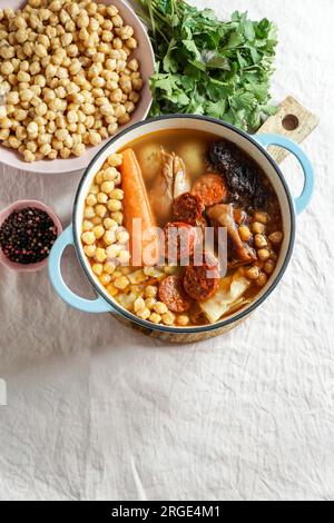 Cocido Madrileño, ein traditionelles spanisches Gericht, Eintopf auf Kichererbsenbasis aus rosafarbenem Keramikfliesen aus Madrid Stockfoto