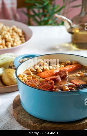 Cocido Madrileño, ein traditionelles spanisches Gericht, Eintopf auf Kichererbsenbasis aus rosafarbenem Keramikfliesen aus Madrid Stockfoto