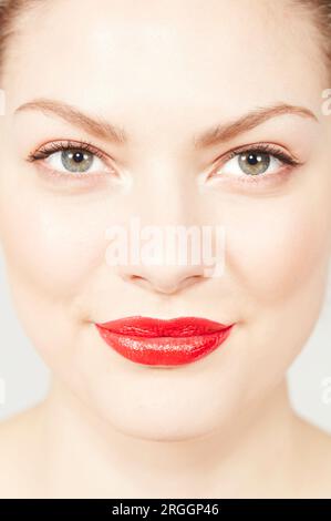 Junge Frau trägt roten Lippenstift Stockfoto