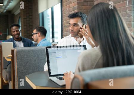 Geschäftsmann mit Smart Phone während der Konferenz Stockfoto
