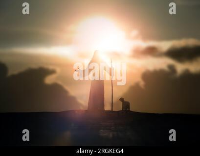 Shepherd Jesus Christ praying and bright sun light and Jesus and sheep silhouette Stock Photo