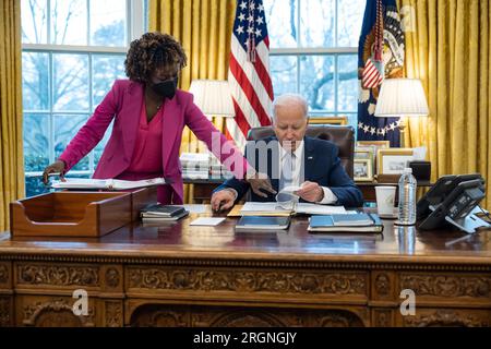Bericht: Präsident Joe Biden trifft sich mit Pressesprecherin Karine Jean-Pierre während einer täglichen Pressekonferenz am Freitag, den 6. Januar 2023, im Oval Office. Stockfoto