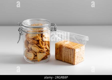 Gesalzene Kekse oder Cracker im Glas und in einer Plastiktüte Stockfoto