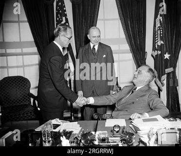 Washington, D.C.: 18. Februar 1938 Präsident Roosevelt gratuliert Joseph P. Kennedy, nachdem er den Eid von Associate Justice Stanley Reed als neuen US-Gesandten für Großbritannien abgelegt hatte. Stockfoto