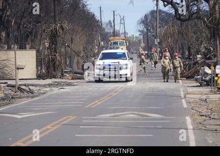 Lahaina, Usa. 10. Aug. 2023. Die Hawaii Army National Guard SAR-Soldaten durchsuchen die Überreste ausgebrannter Häuser nach den Waldbränden, die den Großteil der historischen Stadt am 10. August 2023 in Lahaina, Maui, Hawaii, zerstörten. Waldbrände, die von starken Winden angefacht wurden, haben mindestens 55 Menschen getötet und Tausende von Häusern auf der Insel zerstört. Kredit: MSgt. Andrew Jackson/US Air Force Photo/Alamy Live News Stockfoto