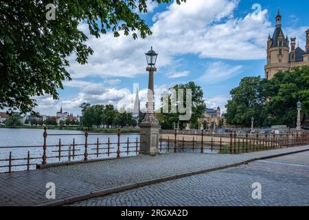 schwerin, Mecklenburg-Vorpommern Germany, 07 06 2023: View from a bridge onto an old street lamp at Lake Schwerin and Schwerin Castle. Stock Photo