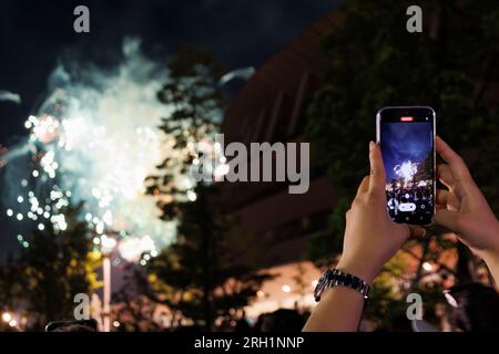 Tokio, Japan. 12. Aug. 2023. Die Menschen genießen das Feuerwerk, das den Himmel in der Nähe des Japan National Stadium in Tokio erhellt. Über dem Meiji-Jingu-Stadion oder dem Rugby-Stadion Chichibunomiya in der Nähe des Olympiastadions wurden etwa 10 Feuerwerke freigesetzt. (Kreditbild: © Rodrigo Reyes Marin/ZUMA Press Wire) NUR REDAKTIONELLE VERWENDUNG! Nicht für den kommerziellen GEBRAUCH! Kredit: ZUMA Press, Inc./Alamy Live News Stockfoto