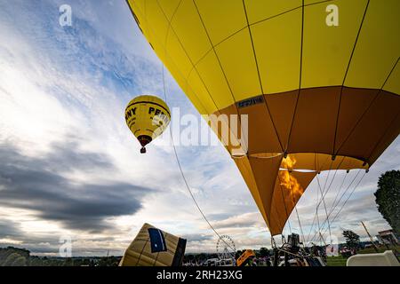 Ballons starten am letzten Tag der Bristol International Balloon Fiesta in Ashton Court, Bristol. Regen und feuchtes Wetter über das Wochenende haben die Ballons in den Himmel getrieben, da die Baumkronen nass wurden und Crews versuchten, sie abzutrocknen. Foto: Sonntag, 13. August 2023. Stockfoto