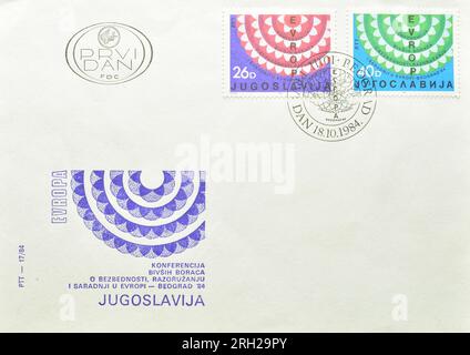 First Day Cover letter with cancelled postage stamps printed by Yugoslavia,  that show Stylized Flower, International War Veterans Conference. Stock Photo