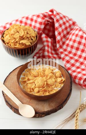 Cornflakes, Müsli mit Milch zum Frühstück, serviert in einer Schüssel am Tisch mit roter Serviette Stockfoto