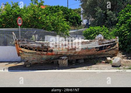 Verlassenes Fischerboot neben der Straße, Skala, Agistri, Saronische Inseln, Griechenland. Stockfoto