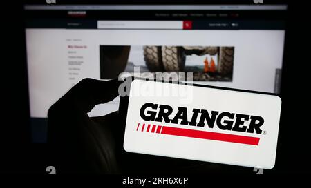 Person, die ein Smartphone mit dem Logo des US Industrial Supply Company W.W. Grainger Inc. Auf dem Bildschirm vor der Website hält. Konzentrieren Sie sich auf das Display des Telefons. Stockfoto