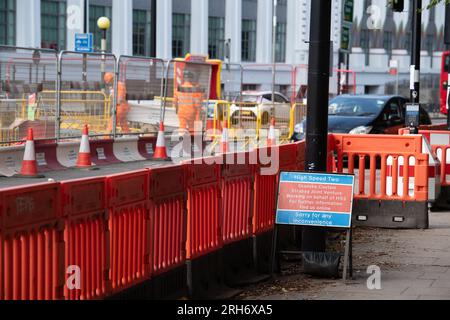 Camden, London, Großbritannien. 10. August 2023. HS2 Hochgeschwindigkeitsarbeiten auf einer Straße außerhalb eines HS2-Komplexes im Nordwesten Londons in Camden, in der Nähe der Euston Station. Die Arbeiten am Hochgeschwindigkeitsbahnprojekt HS2 in Euston in London wurden zwei Jahre lang ausgesetzt. Die beiden Tunnelbohrmaschinen für den Euston-Teil des Projekts sollen nächstes Jahr in der Old Oak Common Station unterirdisch vergraben werden, die dann wieder einsatzbereit ist, falls der zentrale Londoner Teil des viel kritisierten HS2-Projekts wieder grünes Licht erhält. HS2 liegt mit den aktuellen Kostenschätzungen für den Bau des Euston deutlich über dem Budget Stockfoto