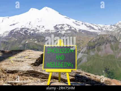 Symbol für Inklusion und Wohlbefinden. Konzeptbegriffe Inklusion und Wohlbefinden auf wunderschöner Kreidetafel. Schöner Elbusberg im Hintergrund. Motivationa Stockfoto