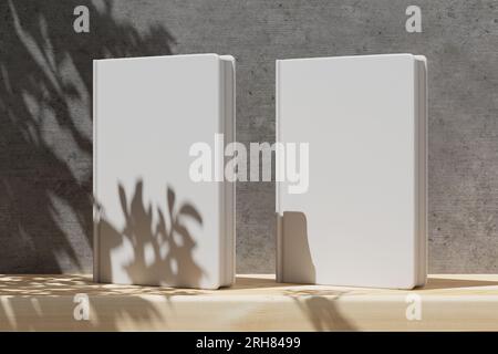 Modell von zwei Büchern, die auf einem Holzregal mit einer grauen Betonwand stehen. Modell für Ihr Cover-Design, Notizbuch. Leere Hülle für dein Design. 3D RE Stockfoto