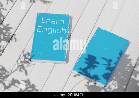 Englisch lernen. Englisches Lehrbuch auf einem weißen Holztisch. Englische Grammatik. Englischsprachiges Lehrbuch zum Sprachenlernen. 3D-Rendering. Stockfoto