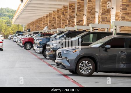 Horizontale Aufnahme einer Reihe von Autos, die an einer belebten Interstate-Tankstelle tanken. Stockfoto