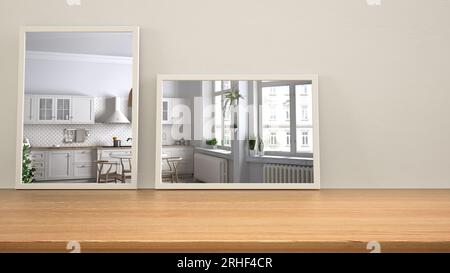 Minimalistische Spiegel auf Holztisch, Schreibtisch oder Regal spiegeln die Innenarchitektur wider. Weiße Küche mit Esstisch und Fenstern. Skandinavischer Hintergrund Stockfoto