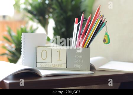 Kalender, 1. September. Zurück zur Schule. Hölzerner ewiger Blockkalender für den Tisch, Holzblöcke zur Anzeige des Datums des Monats. Schreibwaren Stockfoto